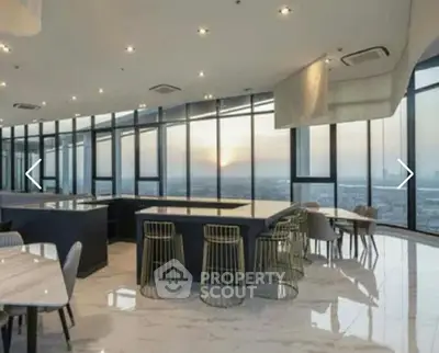 Luxurious high-rise building interior with panoramic city views and modern furnishings.