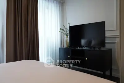 Modern bedroom with sleek TV stand and elegant decor