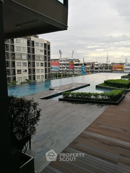 Luxurious rooftop pool with cityscape view in modern apartment complex