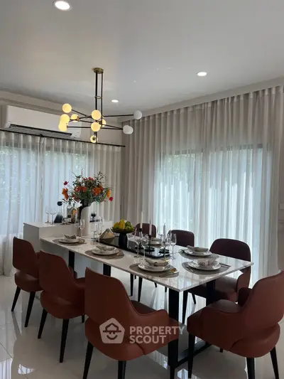 Elegant dining room with modern chandelier and stylish decor, perfect for entertaining guests.