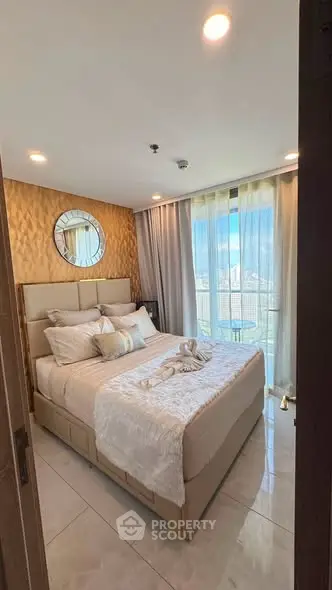 Luxurious bedroom with elegant decor and large window offering natural light and city views.