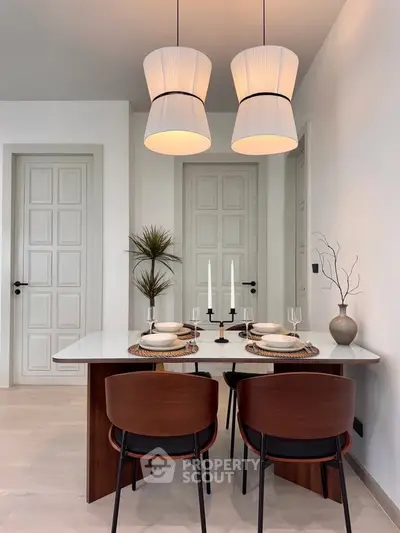Elegant dining area with modern decor and stylish lighting in a contemporary home setting.