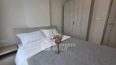 Cozy bedroom with modern decor and elegant floral arrangement