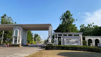 Elegant entrance of Golden Town residential community with lush greenery and modern architecture.