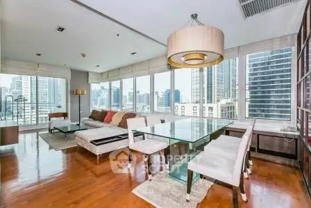 Luxurious corner unit living room with panoramic city views and elegant modern furnishings.