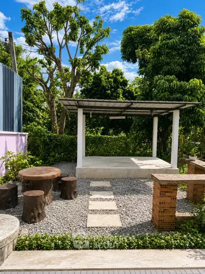 Charming outdoor garden area with rustic seating and lush greenery, perfect for relaxation and gatherings.