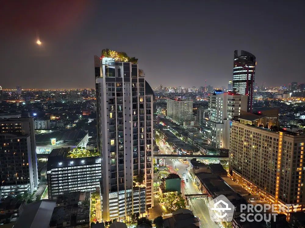 Stunning cityscape view with illuminated skyscrapers and bustling streets at night.