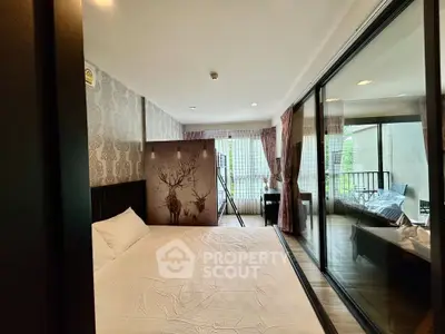 Spacious bedroom with elegant decor and large windows opening to a balcony view.