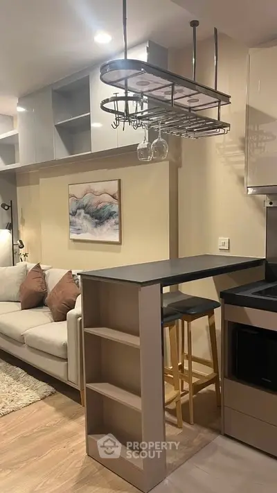 Modern open-layout kitchen with stylish bar counter and cozy living area