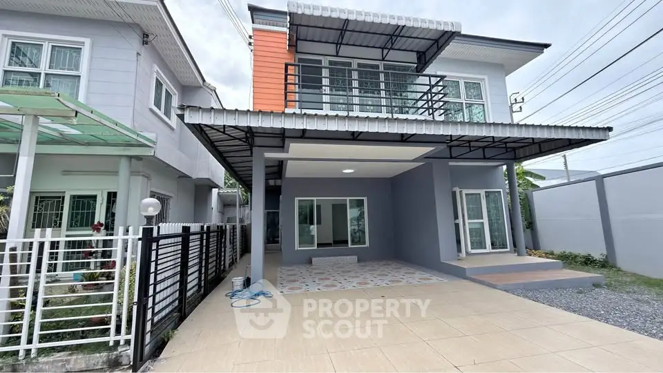 Modern two-story house with spacious driveway and contemporary design.
