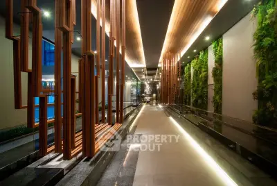 Luxurious modern building entrance with elegant wooden accents and vertical garden walls.
