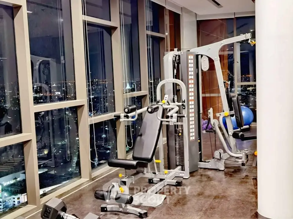 Luxurious high-rise gym with panoramic city views and modern fitness equipment.