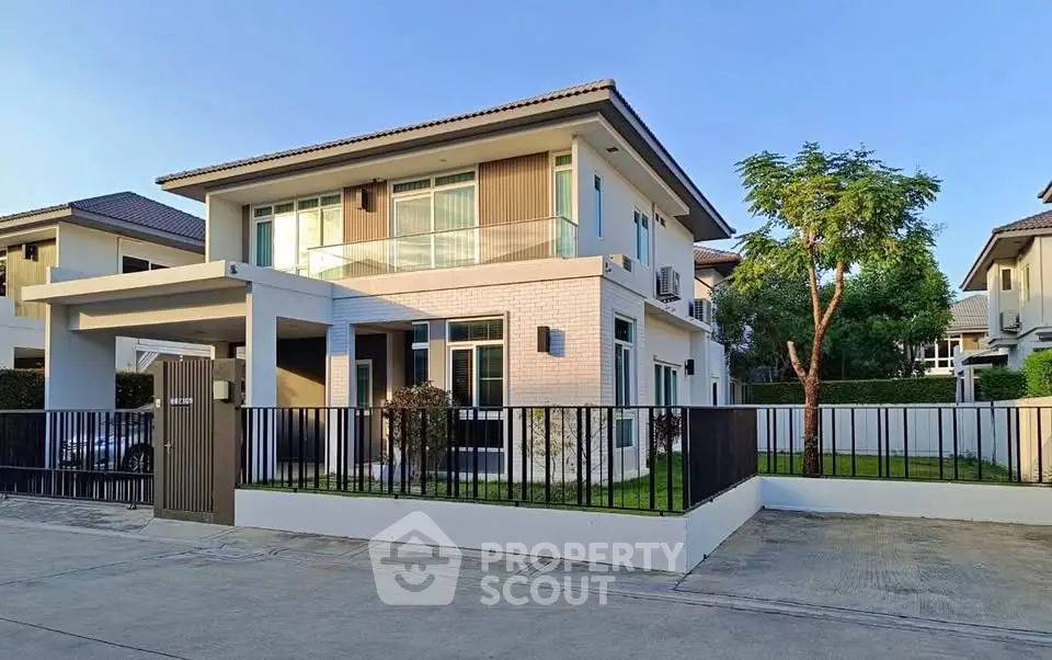Modern two-story house with spacious garden and sleek design in a serene neighborhood.