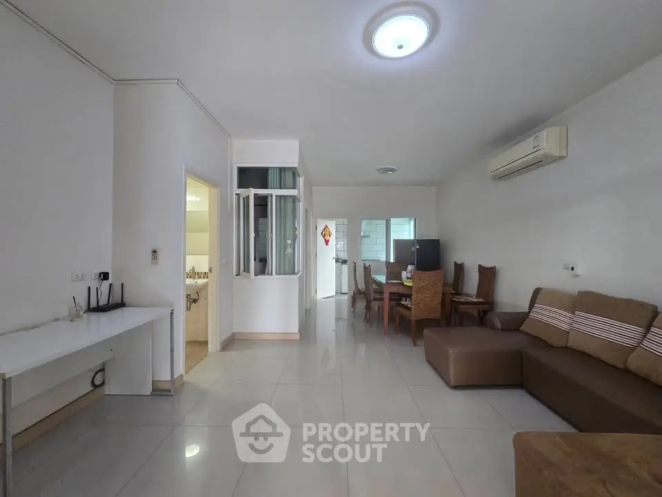 Spacious living room with modern furniture and open layout in a contemporary apartment.