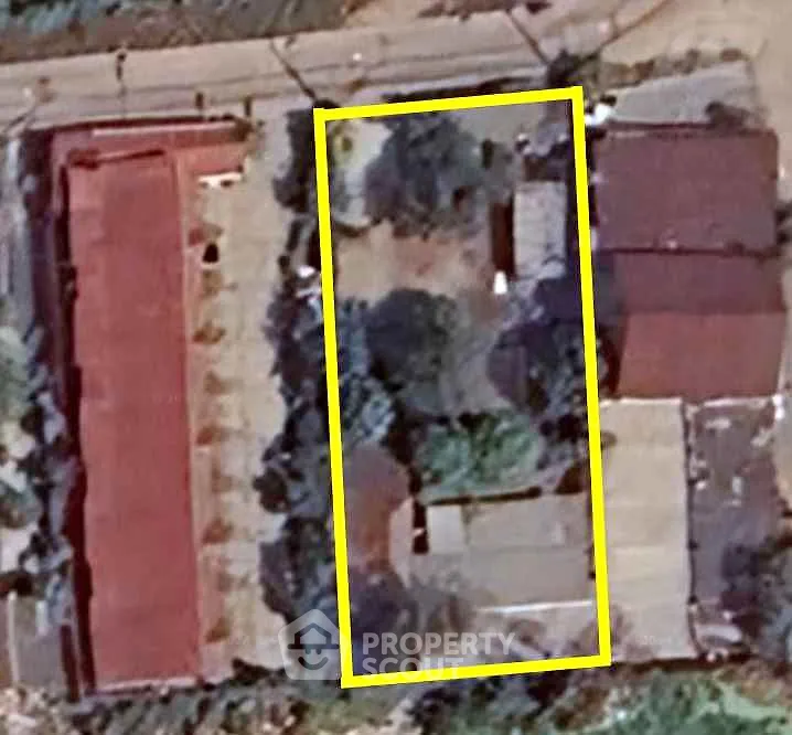 Aerial view of residential property with outlined boundary, showcasing potential for development.
