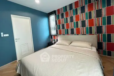 Stylish bedroom with colorful accent wall and modern decor