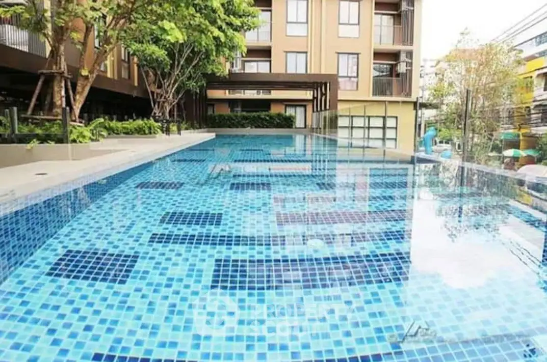 Luxurious apartment complex with stunning outdoor pool and modern design.