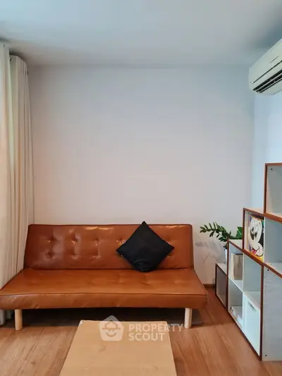 Cozy living room with stylish brown leather sofa and modern decor