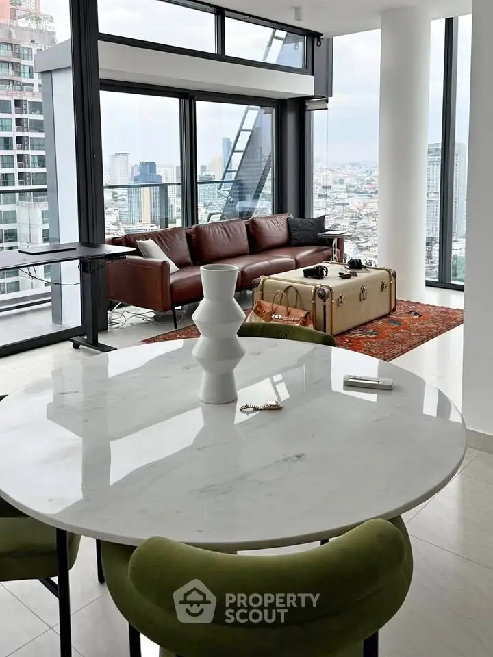 Luxurious modern living room with panoramic city views and elegant furnishings.