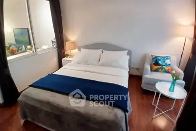 Cozy bedroom with modern decor and ample natural light, featuring a comfortable bed and stylish furnishings.