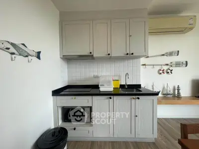 Charming kitchen with modern appliances and nautical decor, perfect for cozy cooking experiences.