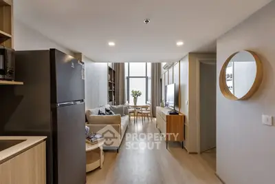 Modern living room with sleek design and open layout, featuring cozy seating and natural light.