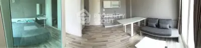 Modern studio apartment with sleek design, featuring a cozy living area and compact kitchen.