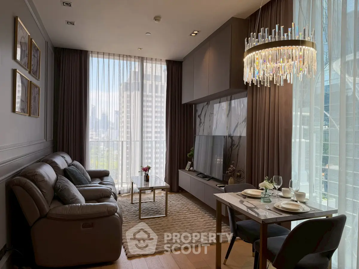 Luxurious modern living room with elegant chandelier and city view, perfect for urban living.