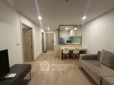 Modern living room with open kitchen layout and cozy seating area