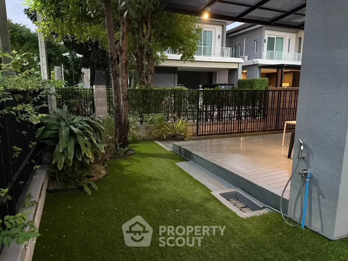 Charming garden with lush greenery and modern patio in a serene residential area