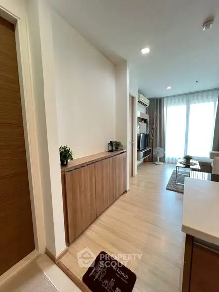 Modern living room with wooden flooring and stylish furniture in a cozy apartment.