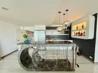 Luxurious modern kitchen with marble island and stylish lighting in open layout apartment.