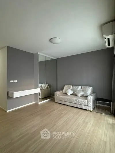 Modern living room with sleek design and mirrored wall