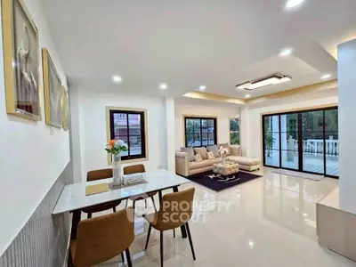 Spacious modern living room with elegant dining area and large windows for natural light.