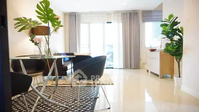 Modern living room with stylish furniture and large windows for natural light.
