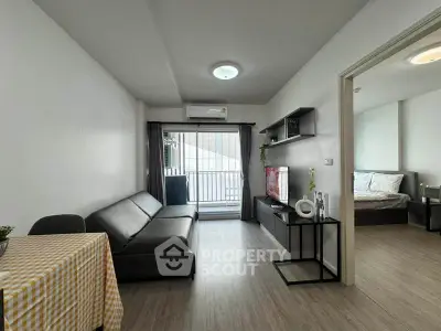 Modern living room with sleek furniture and balcony access in a stylish apartment.