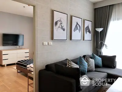 Chic modern living room with plush sofa set, stylish wall art, and ample natural light, perfect for urban living.