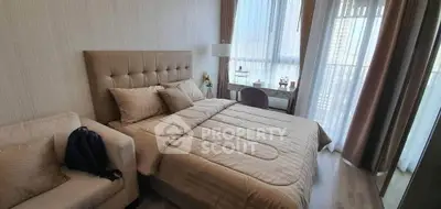 Luxurious bedroom with elegant decor and large windows offering natural light