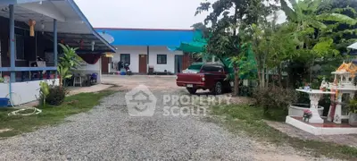 Charming rural property with spacious driveway and lush greenery, ideal for serene living.