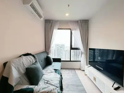 Modern living room with city view, stylish sofa, and large TV, perfect for urban living.