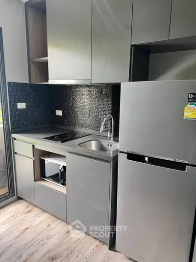 Modern compact kitchen with sleek cabinets and stainless steel appliances