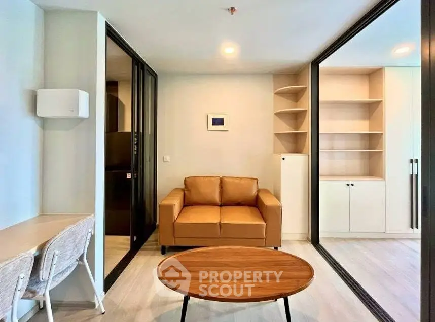 Modern living room with cozy brown sofa and sleek wooden table, featuring built-in shelves and stylish decor.