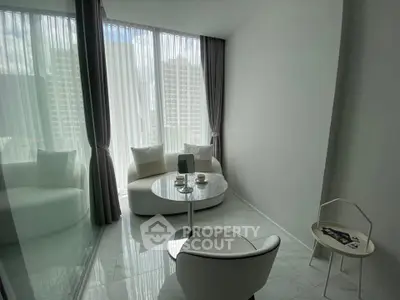 Modern minimalist living room with floor-to-ceiling windows and elegant furniture.