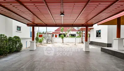Spacious covered patio with modern design and garden view in a luxury home.