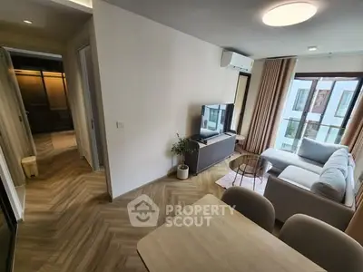 Modern living room with stylish decor and natural light in a contemporary apartment.