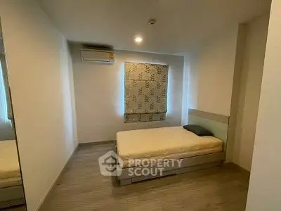 Cozy minimalist bedroom with single bed and air conditioning