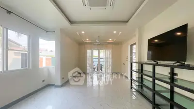 Spacious modern living room with large windows and sleek TV setup