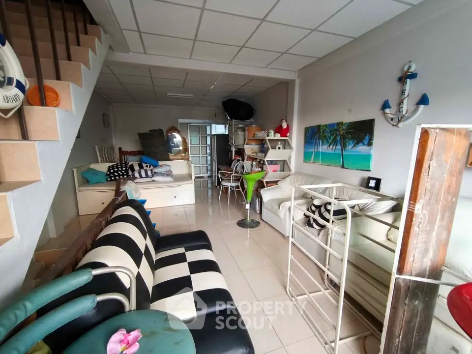 Charming nautical-themed living room with eclectic decor and cozy seating area.
