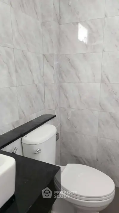 Modern bathroom with marble tiles and sleek fixtures