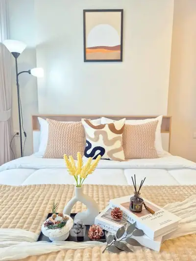 Cozy bedroom with stylish decor and modern lighting, perfect for relaxation and comfort.